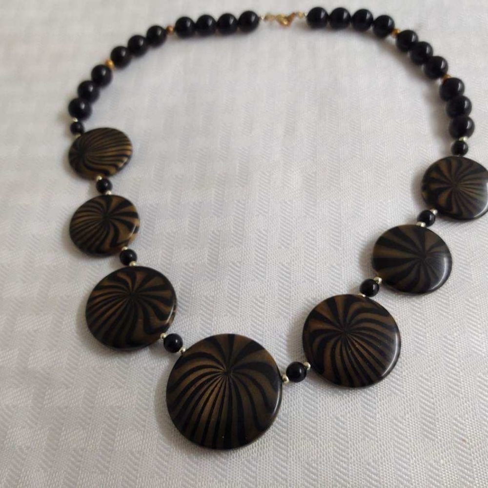 Vintage choker necklace; plastic black beads with striped like discs.